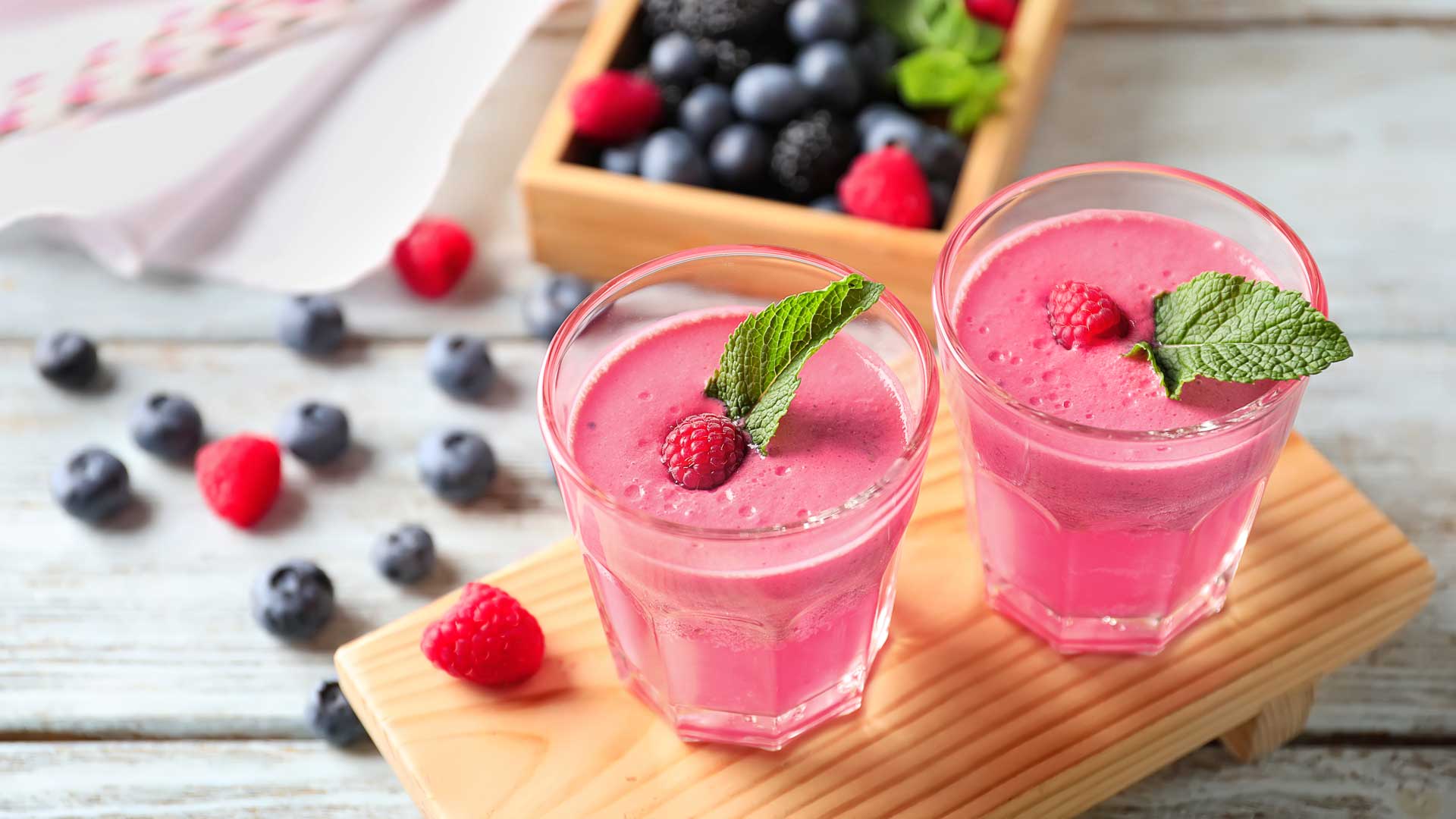 Two glasses filled with pink smoothie